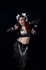 Attractive bellydancer  dancing in tribal makeup and dress