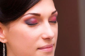 Fototapeta premium brunette young lady closeup prepared by makeup artist