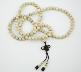 The Tibetan Buddhist mala, beaded rosary, aids counting mantras.