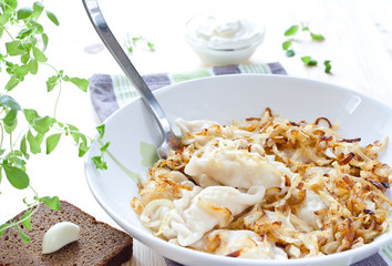 Potato dumplings served with fried onion