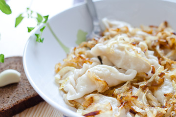 Potato dumplings served with fried onion