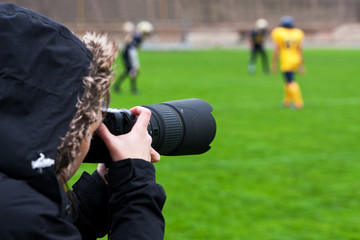 Professional photographer shooting rugby