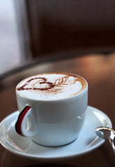 Cup of cappuccino with heart on foam