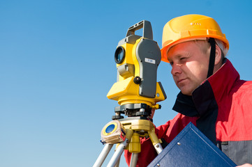 Surveyor looking at the thedolite
