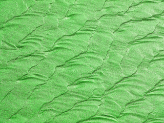 Abstract background of green sand ripples at the beach