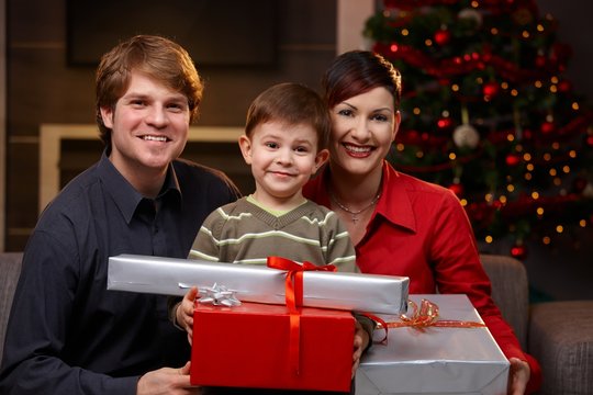 Little boy holding christmas presents