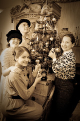 Fototapeta na wymiar Retro photo of Family decorating Christmas tree