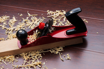 Red plane on brick and shavings.