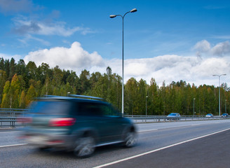 Fototapeta na wymiar fast moving SUV car on highway