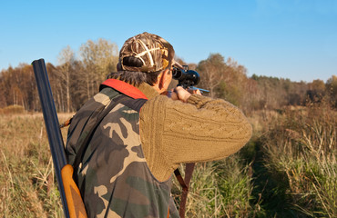 Hunter aiming with rifle