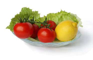 Vegetables on a white background, tomatoes and lemon