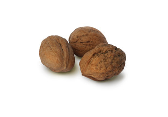Three walnuts on white background, close-up