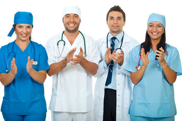 Successful team of doctors clapping together