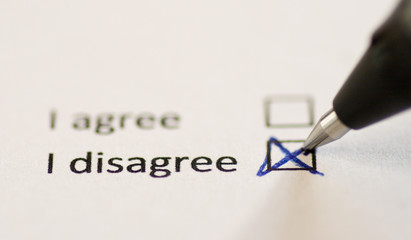a pen is filling out a "disagree box"