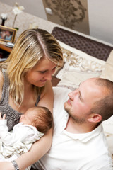 Fototapeta na wymiar Young couple with newborn