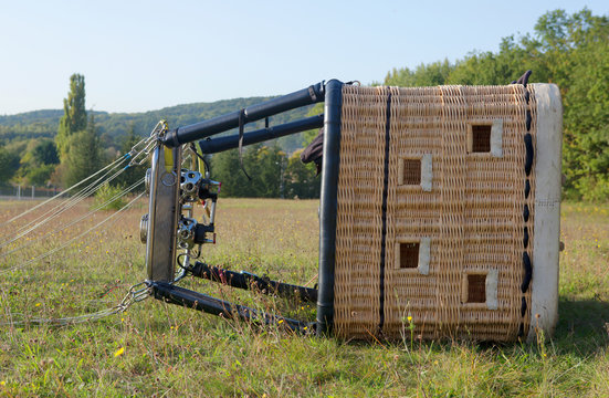 Hot air balloon gondola lying on the ground, ready for the fligh