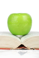 Green apple with books