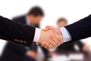 Closeup of business people shaking hands at the office