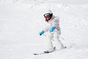 Little girl skiing downhill