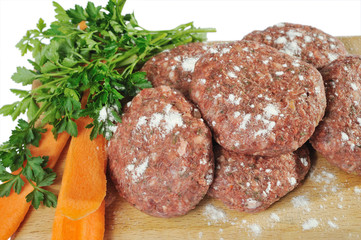 raw meat and vegetables on white background