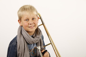 Portrait eines kleinen Jungen mit seiner Posaune