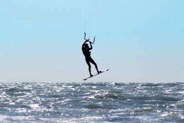 Silhouette of kite surfer in a sea