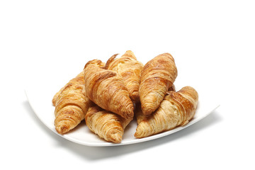 heap of croissants on white plate