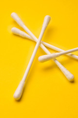 Cotton swabs isolated on yellow background