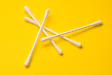 Cotton swabs isolated on yellow background