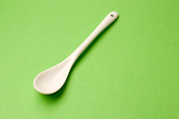 Spoon isolated on green background