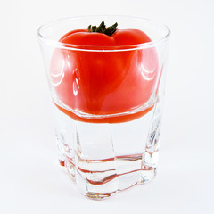 tomato in a glass of water isolated