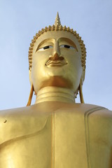 Golden buddha on blue sky background