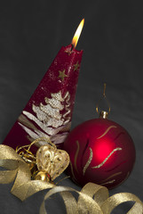 Christmas  still life - red burning candle with evening ball