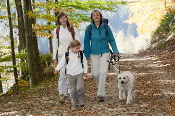 Family with dog on autumn trek