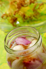 Red and white onions in jar