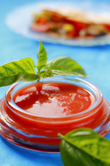 Tomato sauce with basil leaves