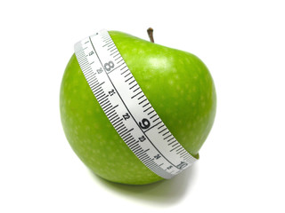 Green Apple with measuring tape on white background