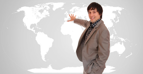 Young attractive businessman with world map