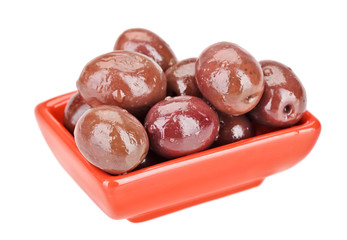 Brown pickled olives fruits in red square plate isolated on whit