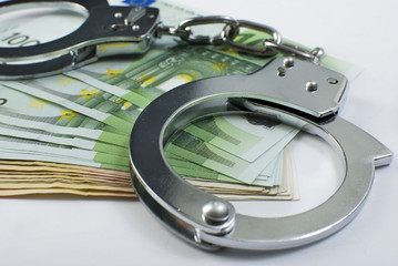 Close-up handcuffs and money