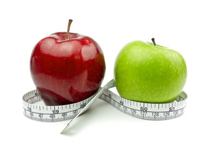 Green Apple and Red Apple with measuring tape on white
