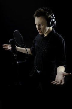 Young man singing in studio