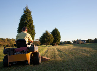 Senior mowing lawn