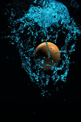 orange ball drop into water