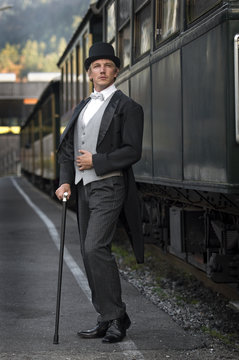 Retro Gesch&auml;ftsmann vor Waggon am Bahnhof