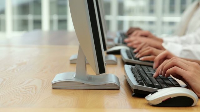 Business Team Working on Computer Terminals