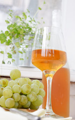 wine and grapes on a light background