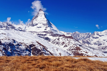 Fototapeta na wymiar Matterhorn peak with dry meadow located at Switzerland