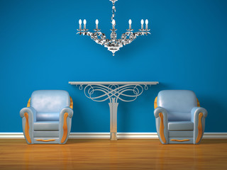 Two chairs with metallic console and silver chandelier