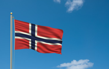 Flag of Norway waving in the wind in front of blue sky